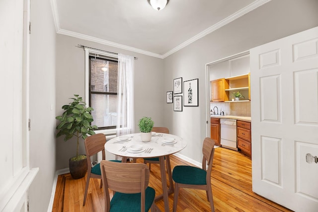 dining area featuring light hardwood / wood-style floors and ornamental molding