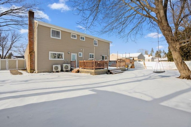 snow covered property featuring ac unit and a deck