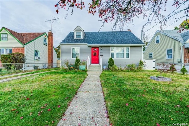 view of front of home featuring cooling unit and a front lawn