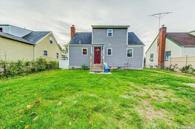 rear view of property with a lawn