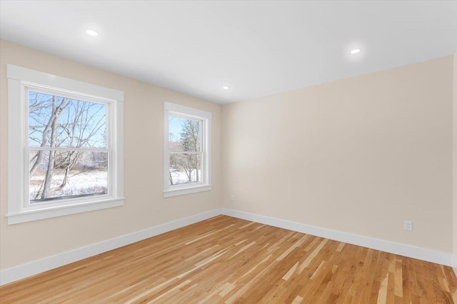 spare room featuring light hardwood / wood-style flooring