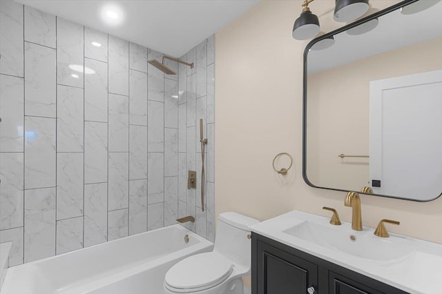 full bathroom featuring tiled shower / bath, vanity, and toilet