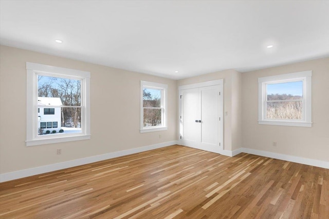 unfurnished bedroom with light hardwood / wood-style floors and a closet