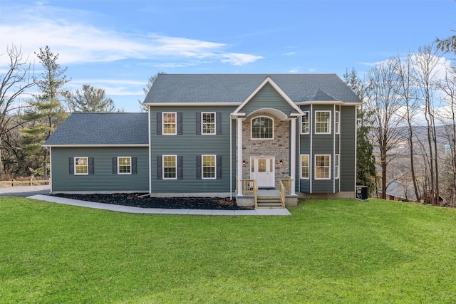 view of front of house with central AC unit and a front lawn