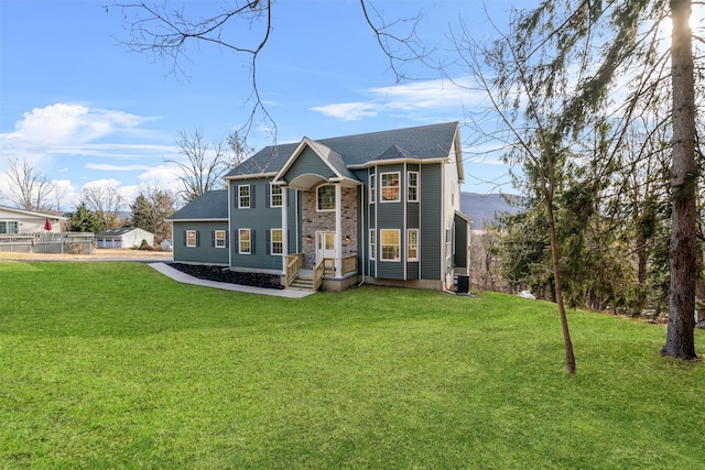 view of front of house featuring cooling unit and a front yard