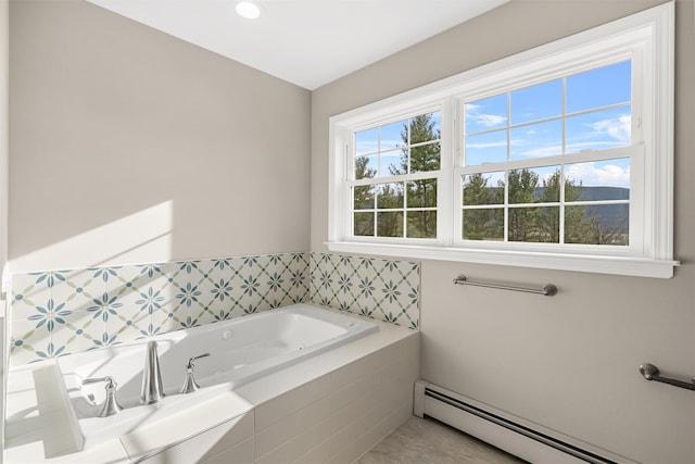 bathroom featuring tiled bath and baseboard heating