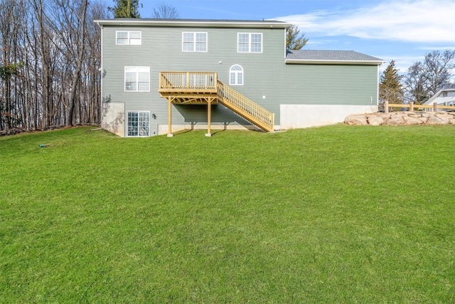 back of house with a deck and a yard