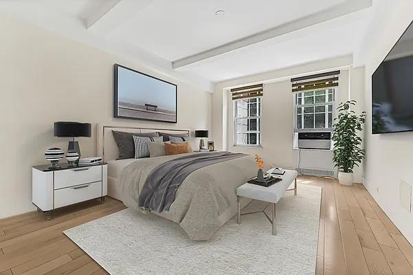 bedroom with beam ceiling and wood-type flooring