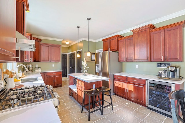 kitchen featuring sink, pendant lighting, a center island with sink, wine cooler, and stainless steel fridge