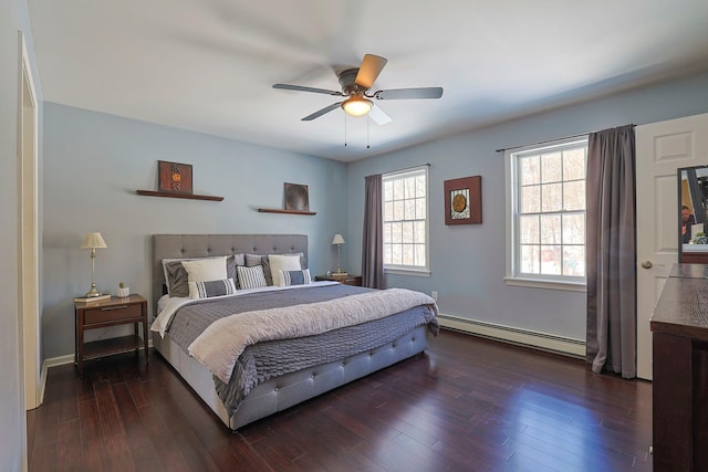 bedroom featuring ceiling fan, baseboard heating, and dark wood-type flooring