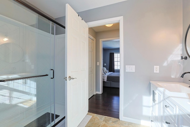 bathroom featuring walk in shower and vanity