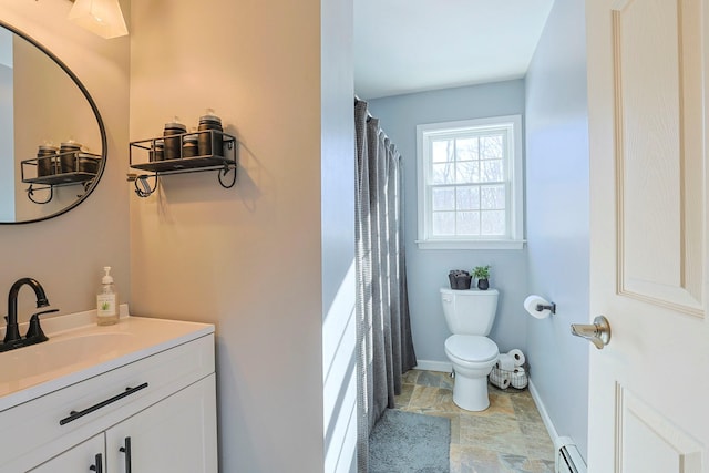 bathroom featuring a baseboard radiator, toilet, and vanity