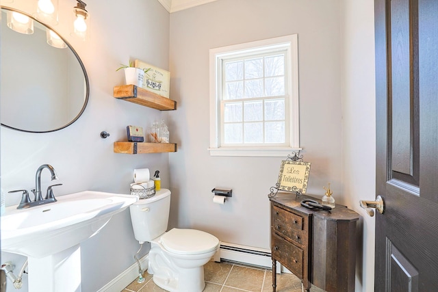 bathroom with tile patterned floors, toilet, a baseboard heating unit, and sink