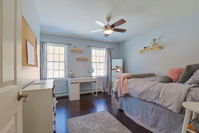 bedroom featuring baseboard heating, dark hardwood / wood-style floors, and ceiling fan