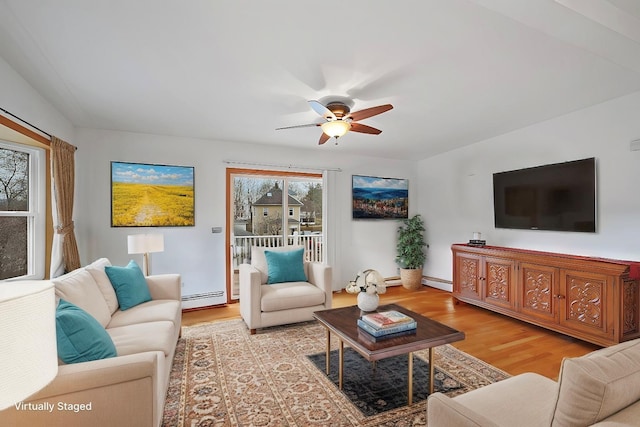 living room with ceiling fan, light hardwood / wood-style flooring, and a baseboard radiator