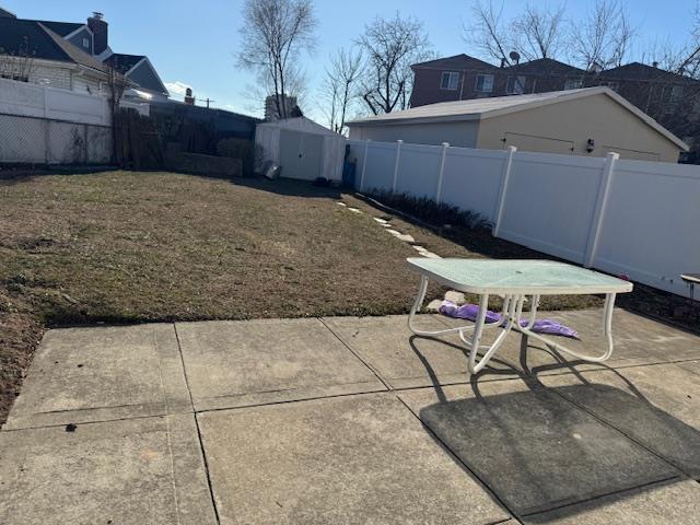 view of yard with a shed and a patio area