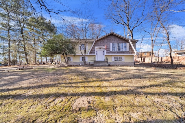 split foyer home with a front lawn