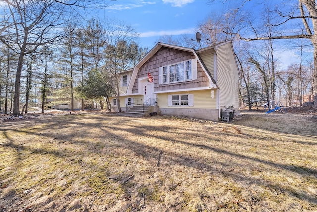 rear view of property with a lawn