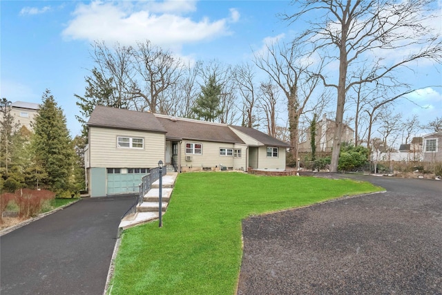 view of front of house featuring a front yard and a garage