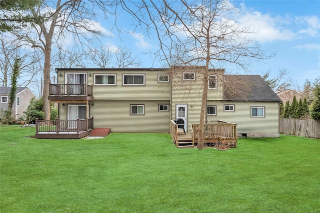 rear view of property featuring a lawn, a balcony, and a deck