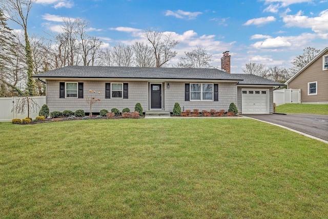 single story home featuring a garage and a front yard