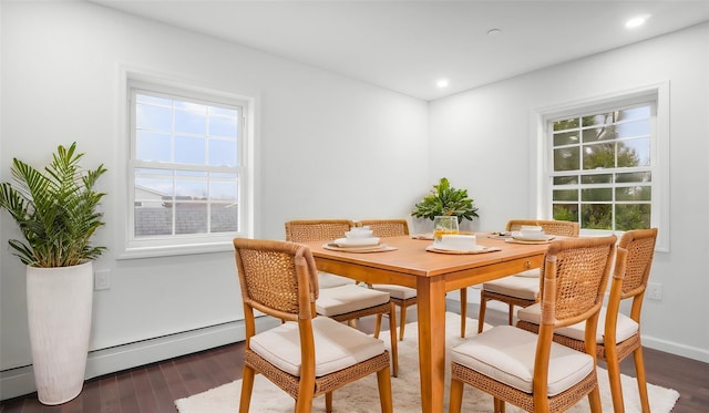 dining space featuring dark hardwood / wood-style flooring and a baseboard heating unit