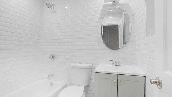 full bathroom featuring vanity,  shower combination, and toilet