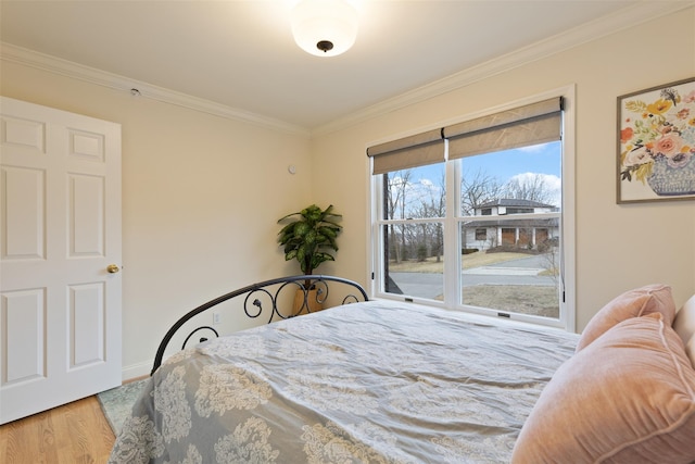 bedroom featuring crown molding and wood finished floors