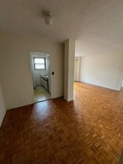 bonus room featuring dark parquet floors