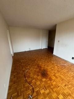 empty room featuring parquet flooring