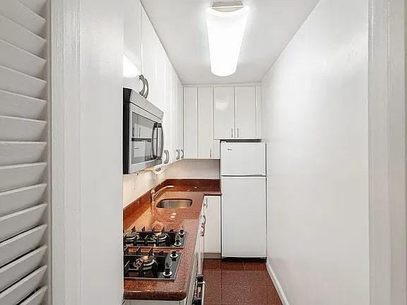 kitchen with white cabinets, stainless steel appliances, and sink