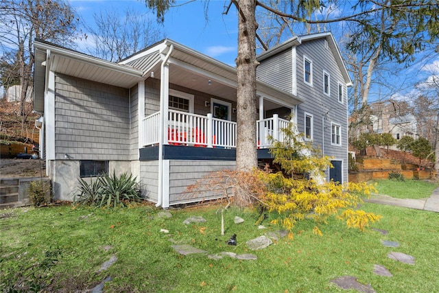 view of property exterior with a porch and a lawn