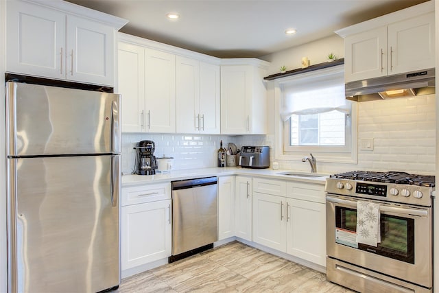 kitchen with sink, white cabinetry, backsplash, and appliances with stainless steel finishes