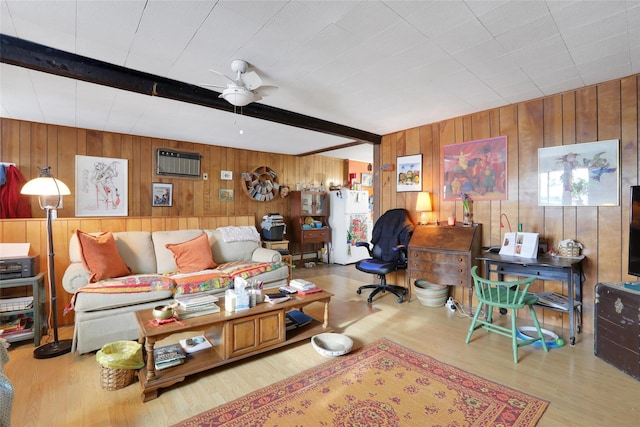 living room with an AC wall unit, ceiling fan, light hardwood / wood-style flooring, and beamed ceiling