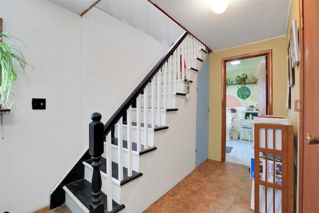 staircase with ornamental molding