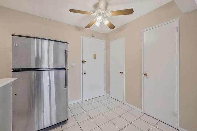 kitchen featuring stainless steel refrigerator, ceiling fan, and light tile patterned flooring