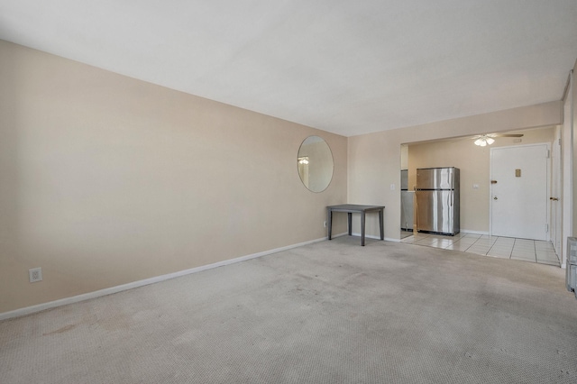 unfurnished room featuring light carpet and ceiling fan