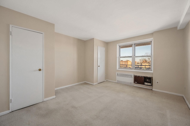 carpeted spare room with radiator heating unit