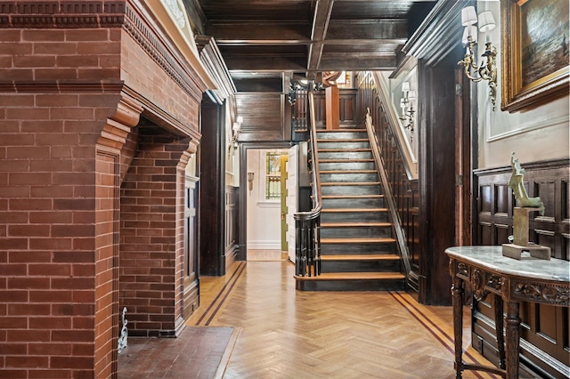 stairway featuring beam ceiling, parquet flooring, crown molding, and coffered ceiling