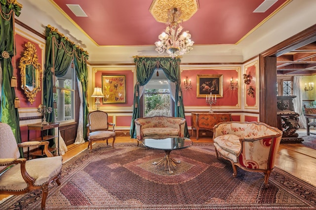 living area featuring wood-type flooring, a wealth of natural light, and a notable chandelier