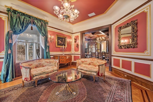 living area with a chandelier, crown molding, and parquet flooring