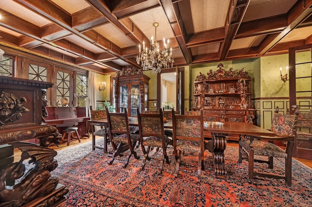 dining room with beam ceiling, an inviting chandelier, and coffered ceiling