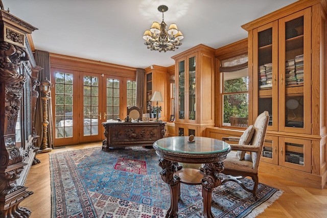 living area featuring french doors, an inviting chandelier, and light parquet floors