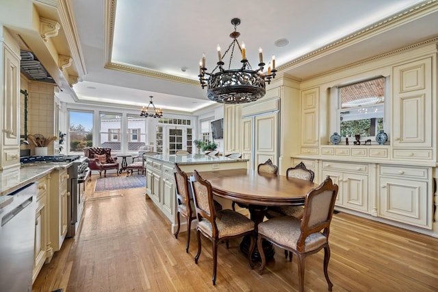 dining room with a tray ceiling, a notable chandelier, french doors, crown molding, and light hardwood / wood-style flooring