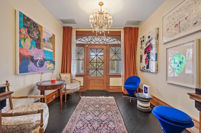 sitting room featuring an inviting chandelier and dark hardwood / wood-style flooring