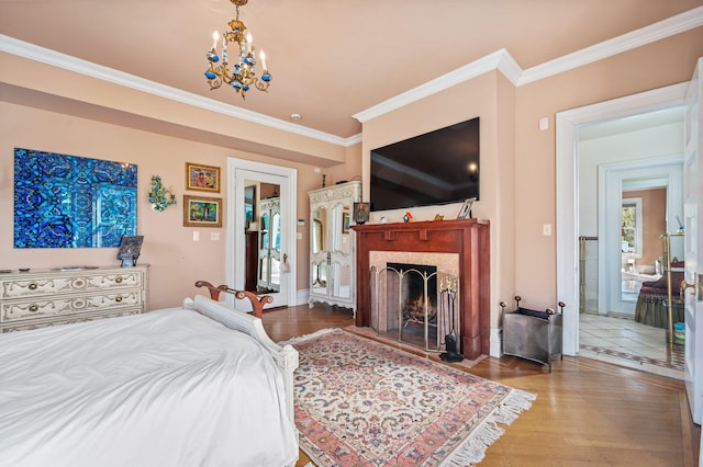 bedroom with crown molding, wood-type flooring, and a notable chandelier