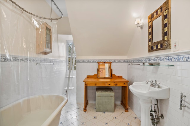 bathroom featuring tile walls, tile patterned floors, shower / tub combo, and sink