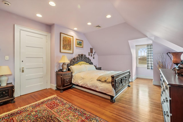 bedroom featuring vaulted ceiling and light hardwood / wood-style floors