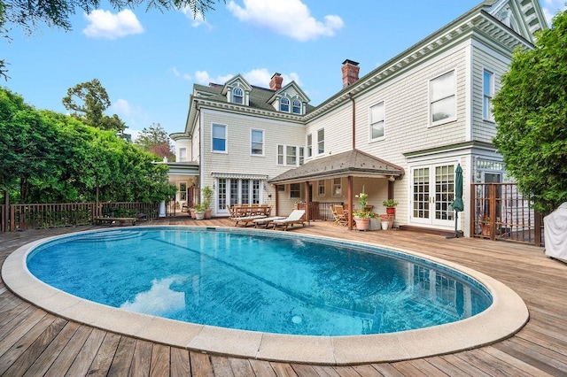 11 Vermont Ave, White Plains, NY 10606 - back of property featuring french doors, a deck, and a chimney
