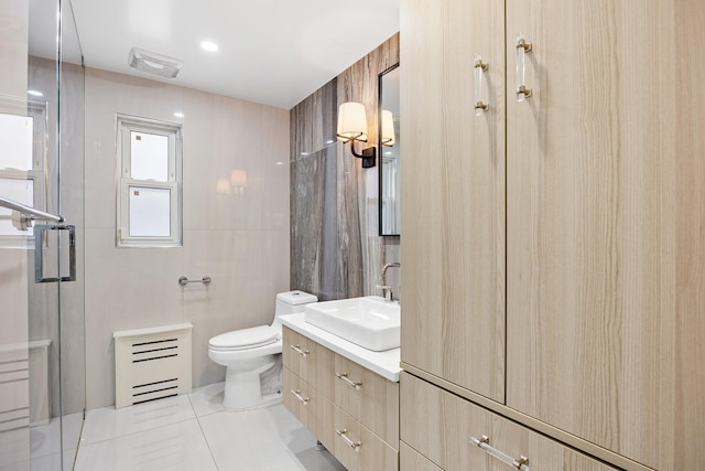 bathroom with tile patterned flooring, vanity, toilet, and walk in shower